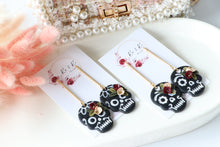 Load image into Gallery viewer, Floral Embossed Skull Floral Dangle Polymer Clay Earrings – Handmade Gothic Floral Earrings | Spooky Elegant Halloween Jewelry | KeandKi Designs