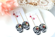 Load image into Gallery viewer, Embossed Skull Floral Dangle Polymer Clay Earrings – Handmade Gothic Floral Earrings | Spooky Elegant Halloween Jewelry | KeandKi Designs