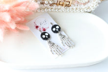 Load image into Gallery viewer, Tiny Skull Head & Steel Skeletal Hand Dangle Earrings – Handmade Gothic Halloween Jewelry | Polymer Clay Skull Earrings | KeandKi Designs